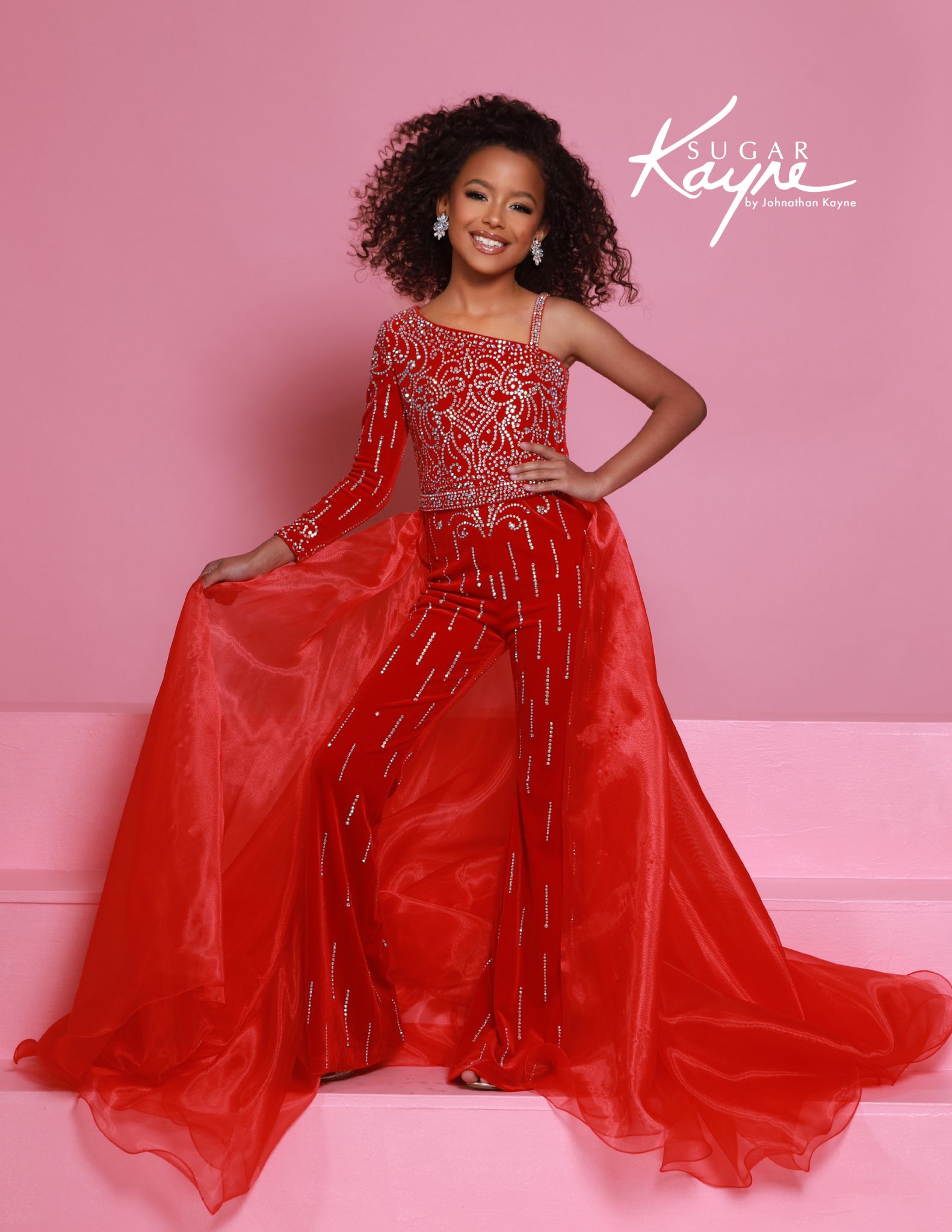 Red beaded one-sleeve girls jumpsuit with dramatic red overskirt, ideal for pageants, talent performances, and stage competition.